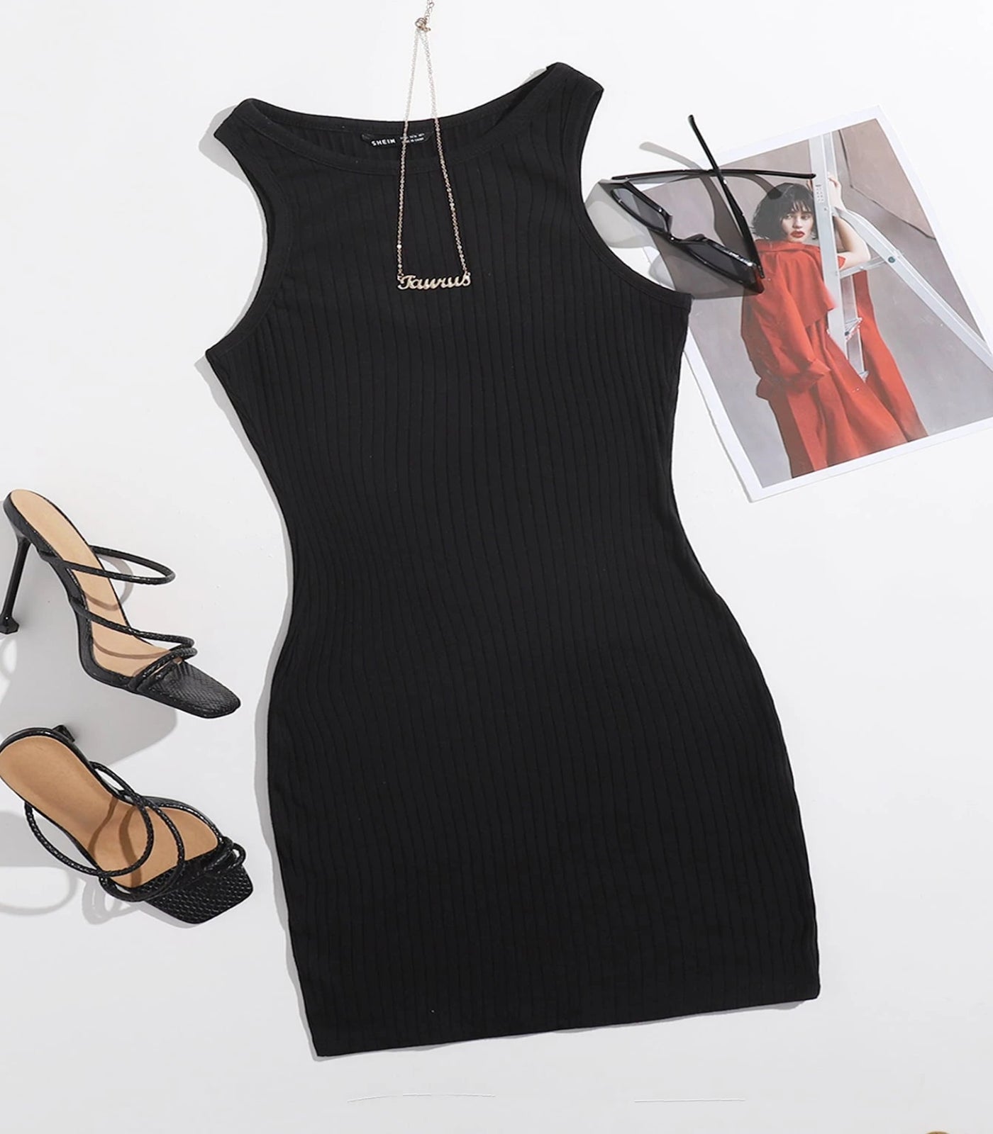 Black ribbed dress with gold necklace, black high-heeled sandals, and a photo of a red dress in the background.