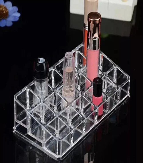 Clear acrylic lipstick holder with lipsticks on a black background