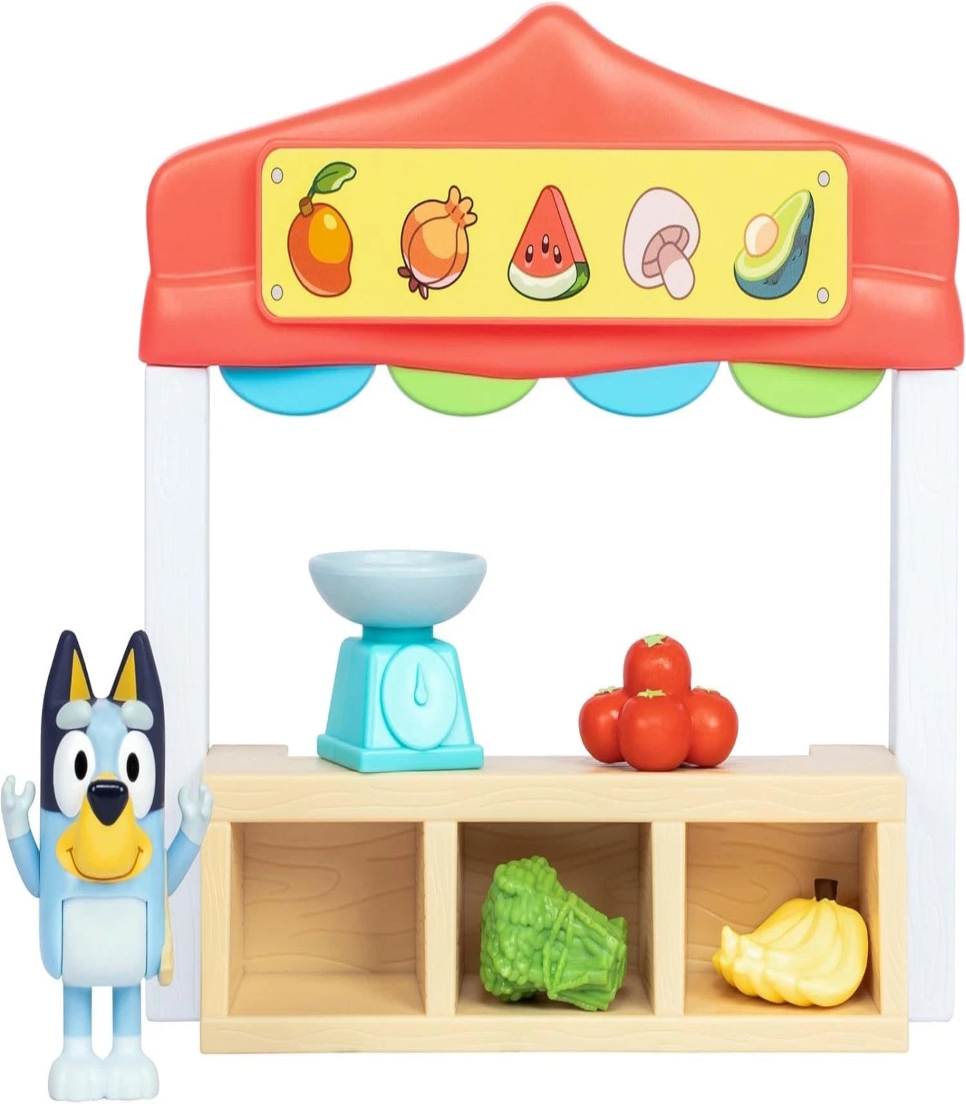 Toy fruit stand with vegetables and a character figure on a white background