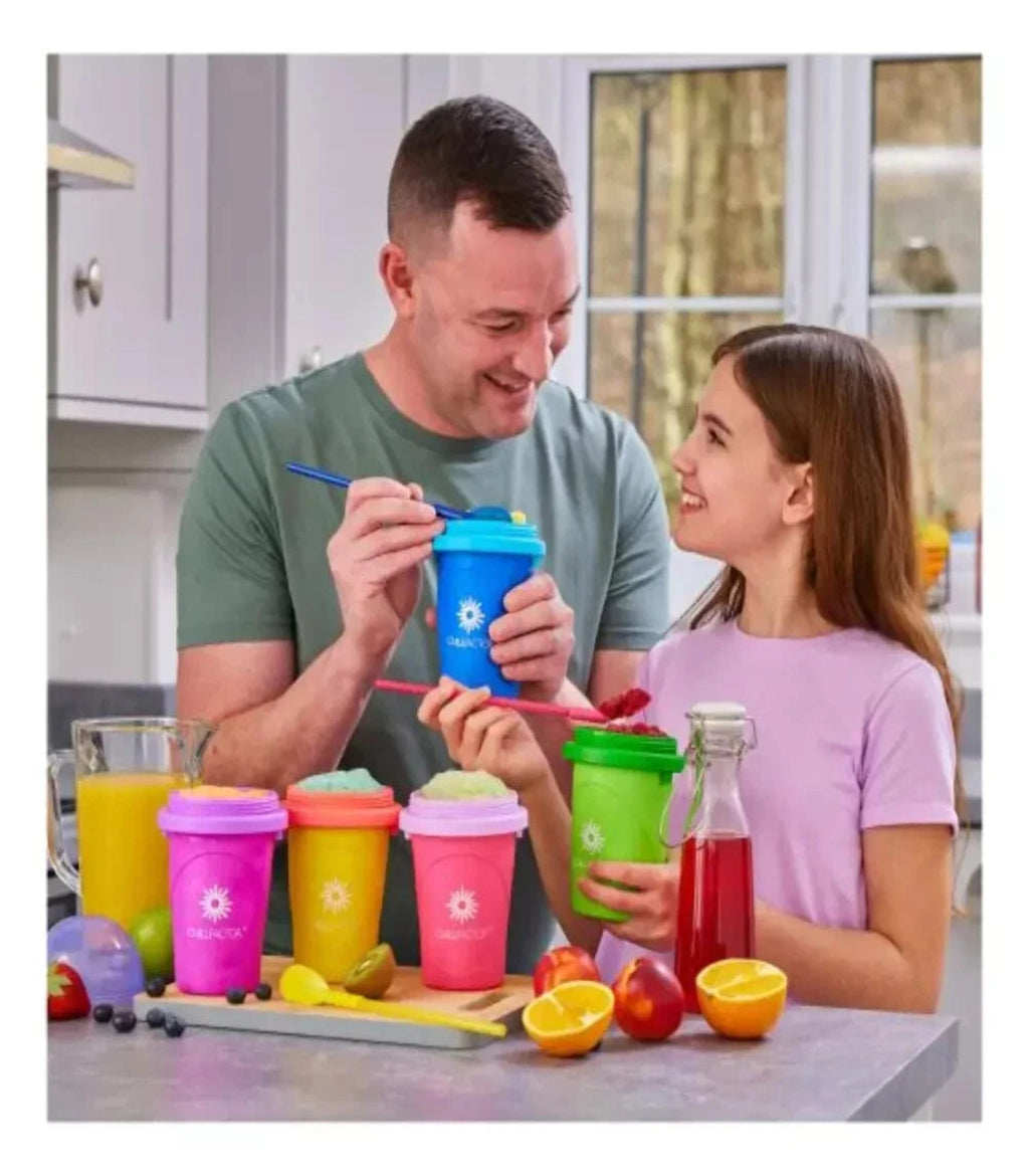 Man and young girl in a kitchen with colorful smoothie cups and juice bottles.