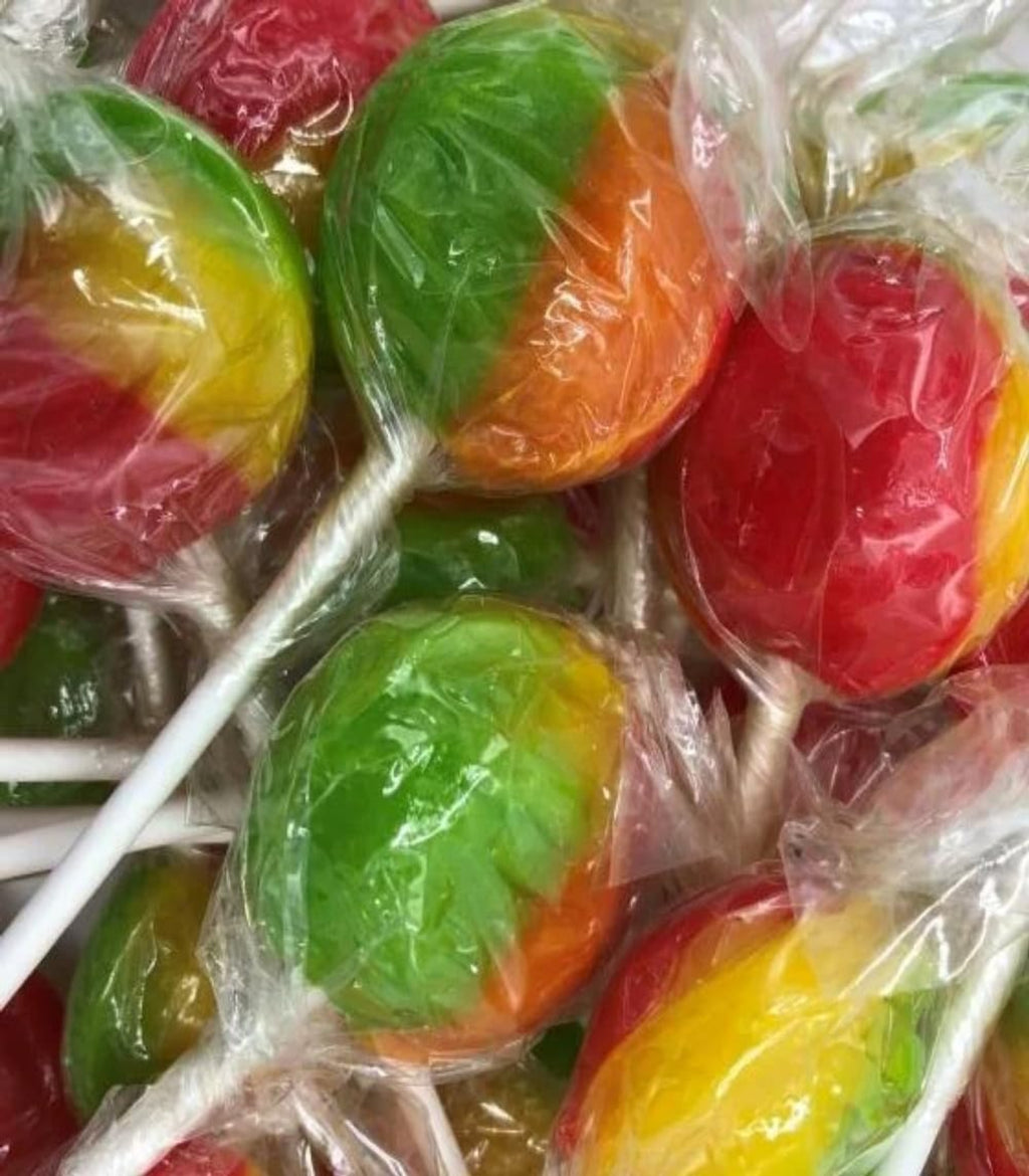 Colorful lollipops in red, green, and orange on sticks, wrapped in clear plastic.