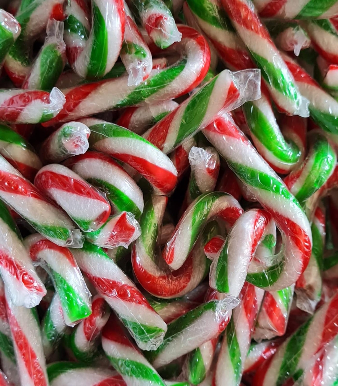 Close-up of a pile of red, green, and white candy canes.
