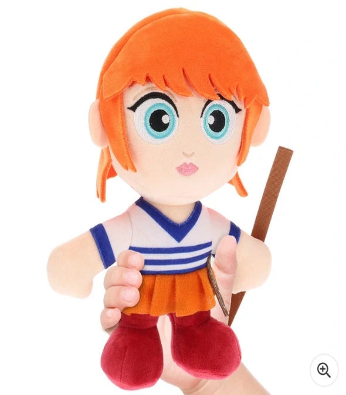 Plush toy of an animated character with orange hair and a staff on a white background