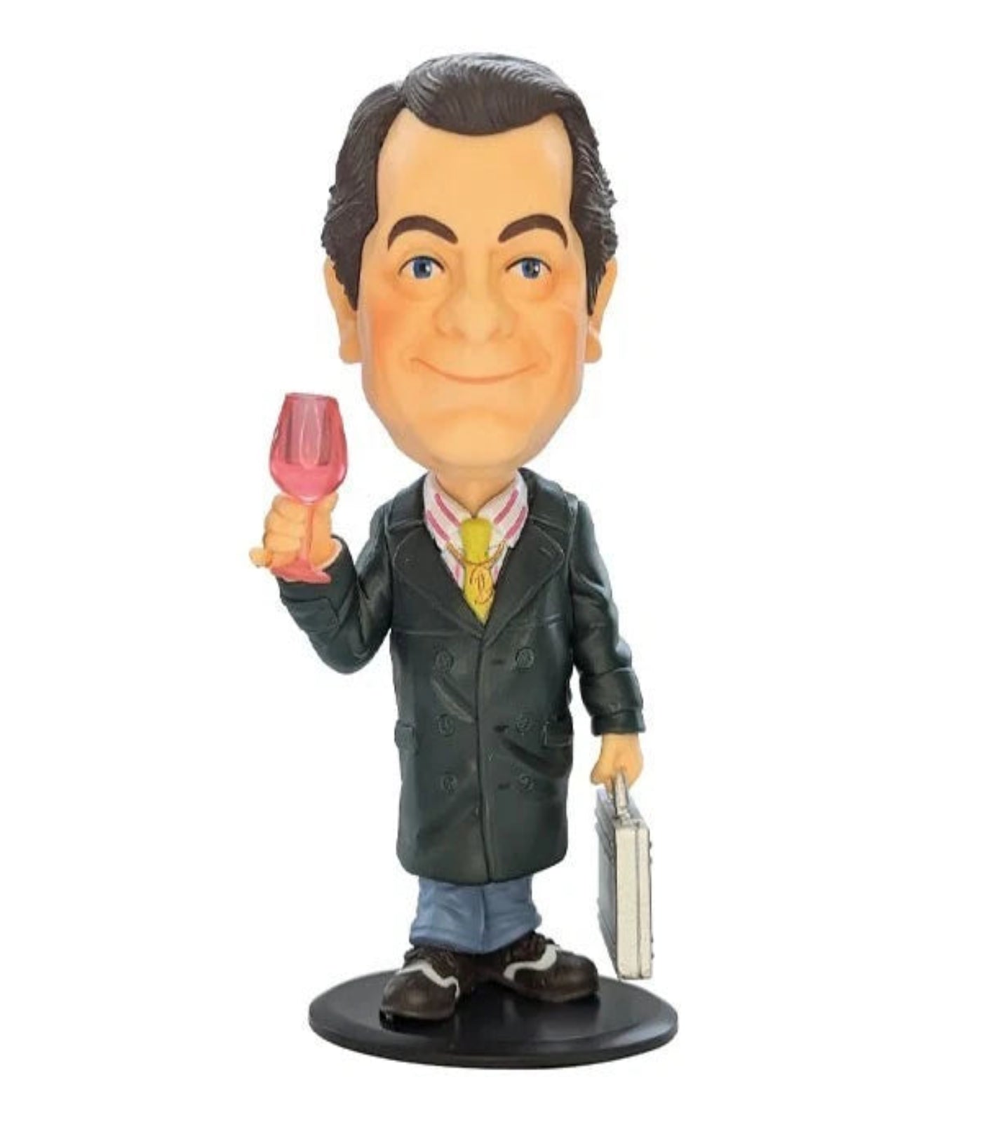 Figurine of a man holding a glass and a briefcase on a white background