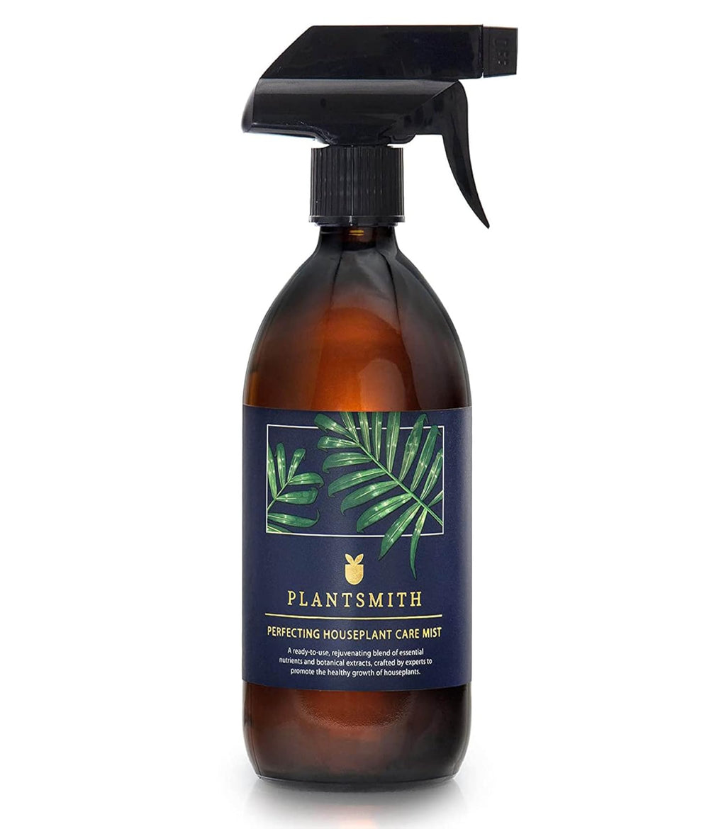 Brown spray bottle with a label featuring green leaves on a white background