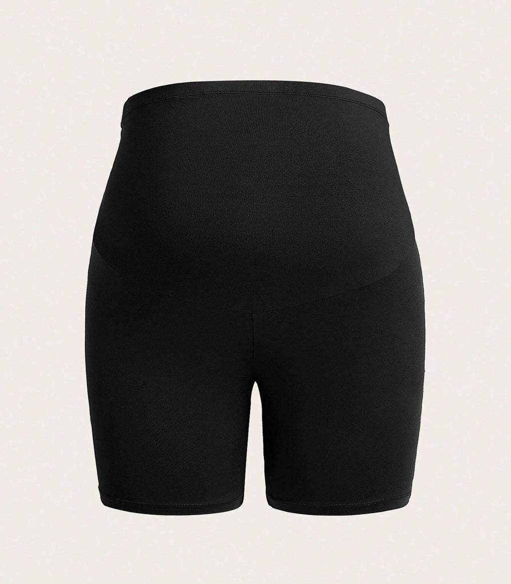 Black athletic shorts on a beige background