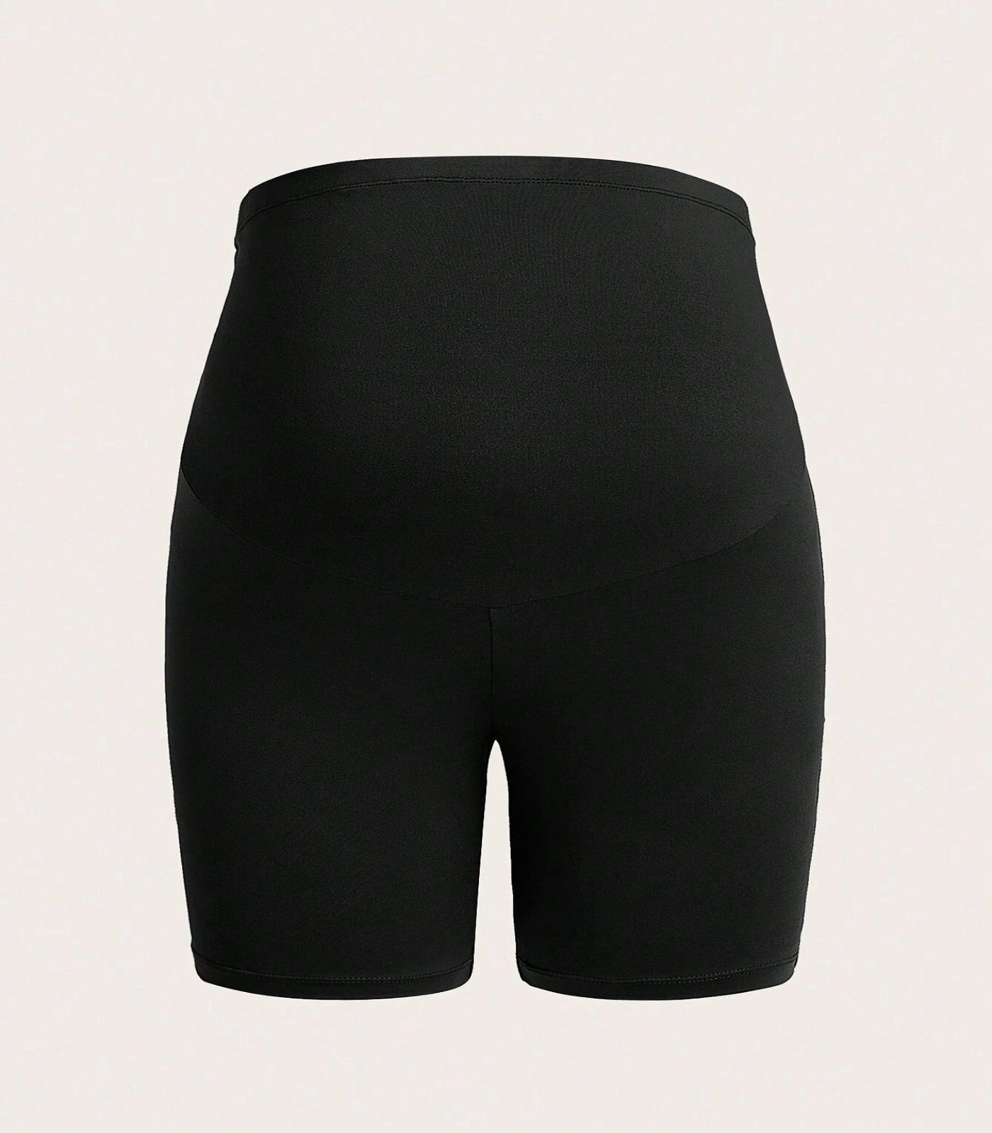 Black athletic shorts on a beige background