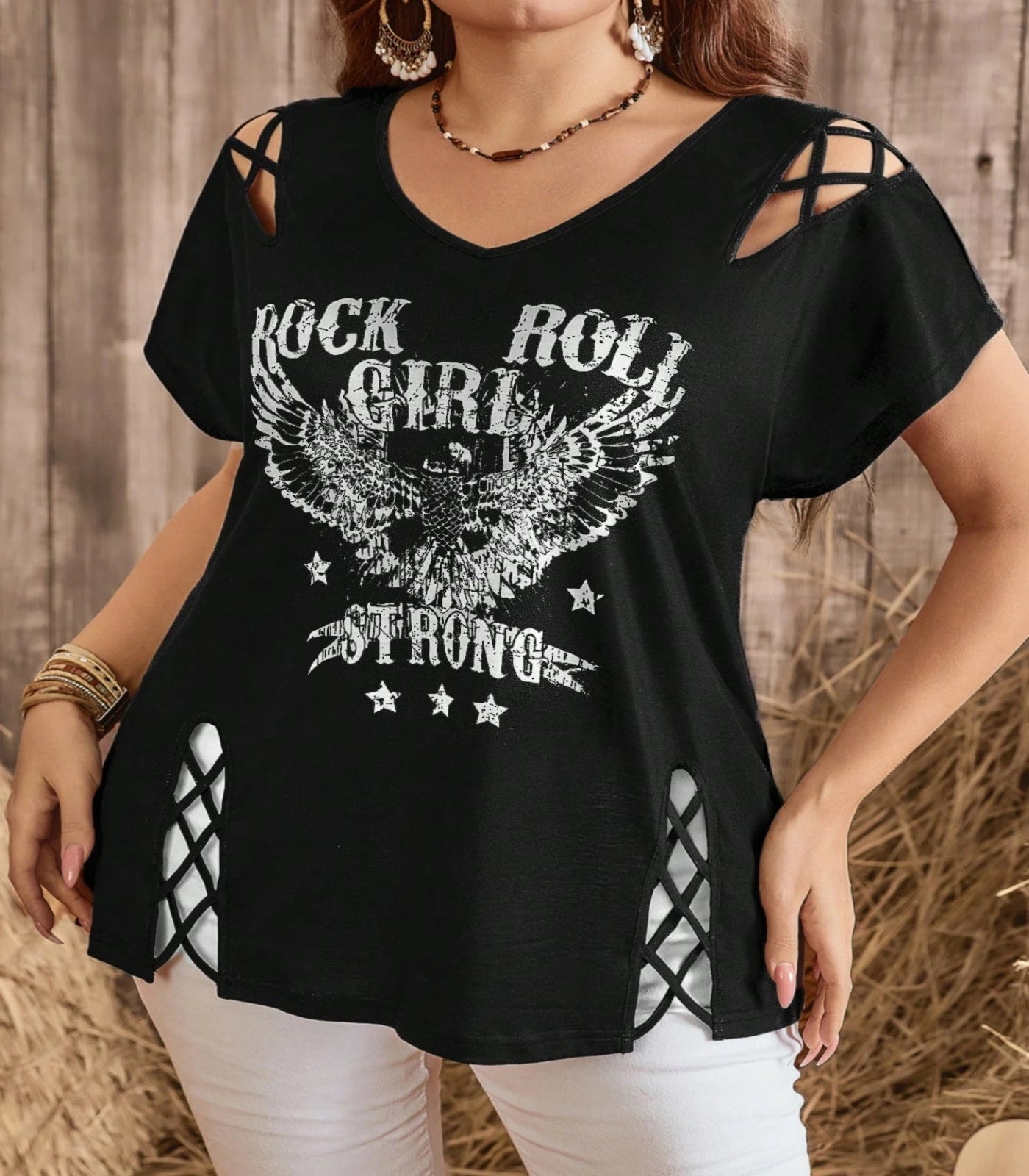Black t-shirt with 'Rock Roll Girl Strong' design worn by a person against a wooden background