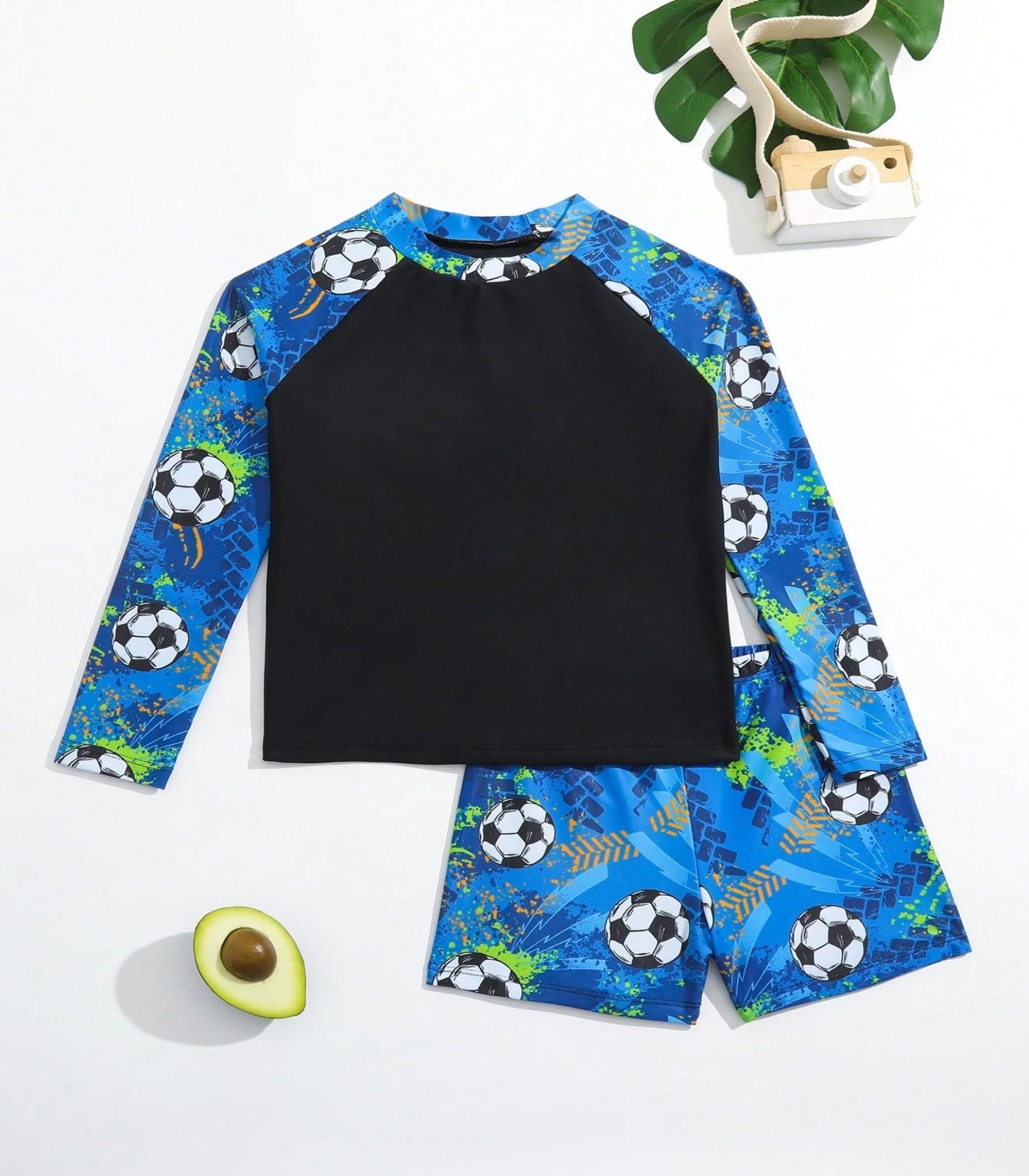 Children's swimsuit set with soccer ball pattern on a white background