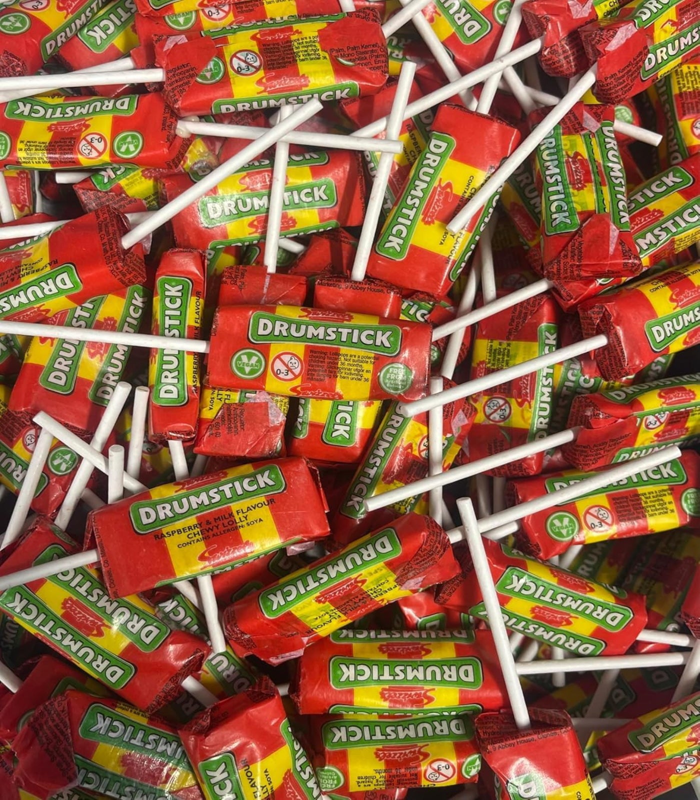 Stack of Drumstick lollipops in red and yellow packaging.