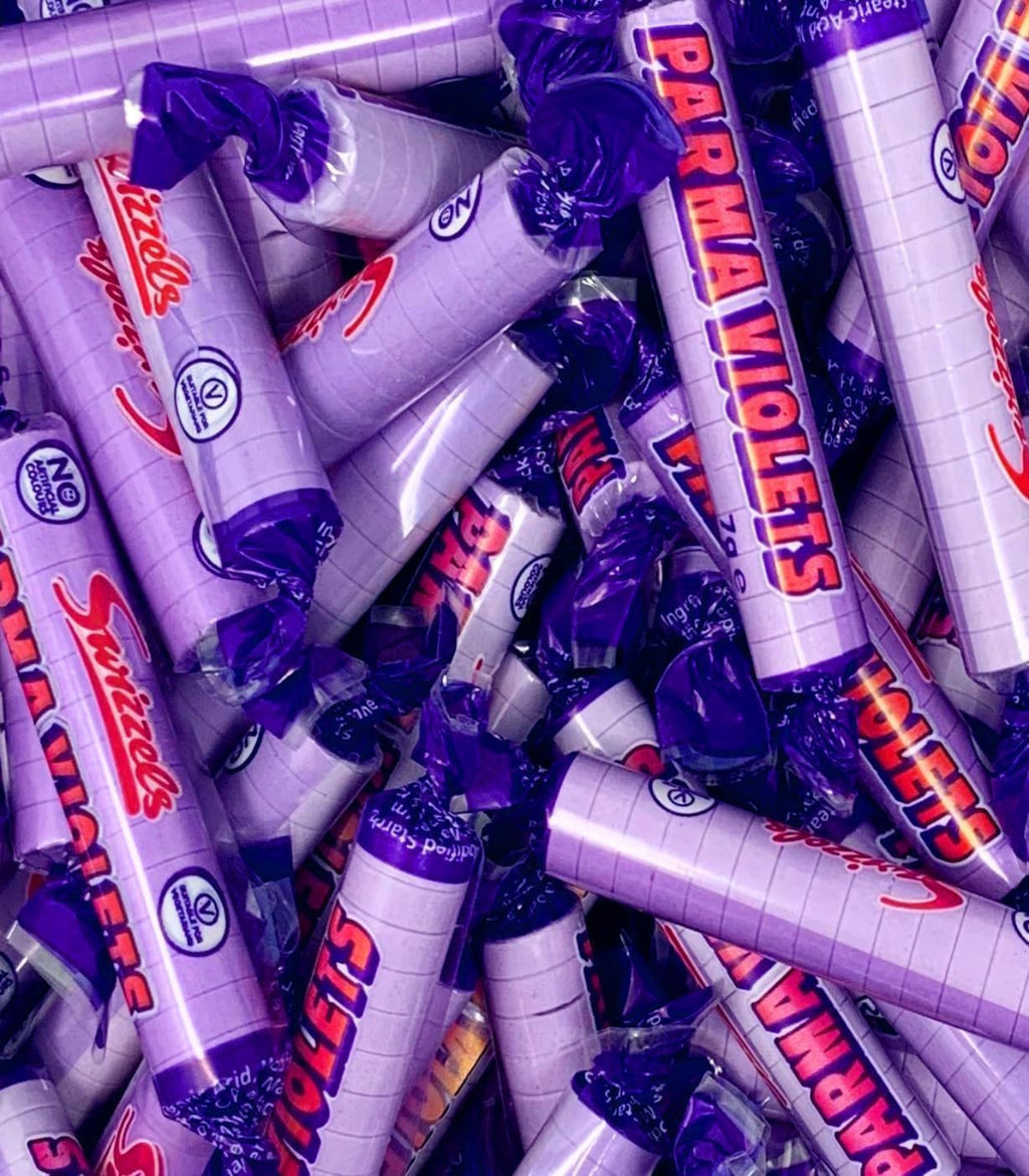 Pile of Parma Violets candy bars with purple and white packaging.