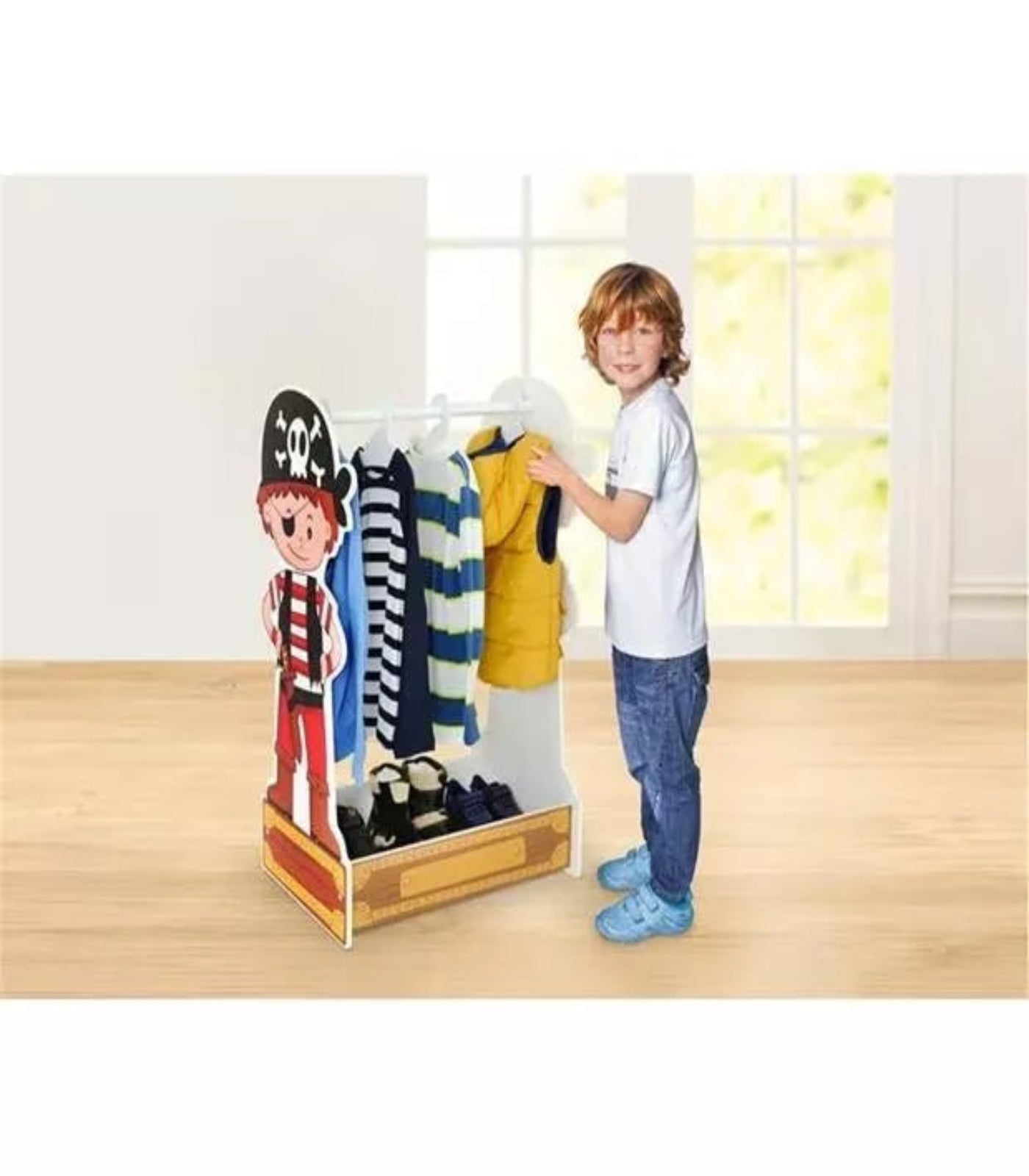 Child standing next to a clothing rack with various garments in a room with a window.